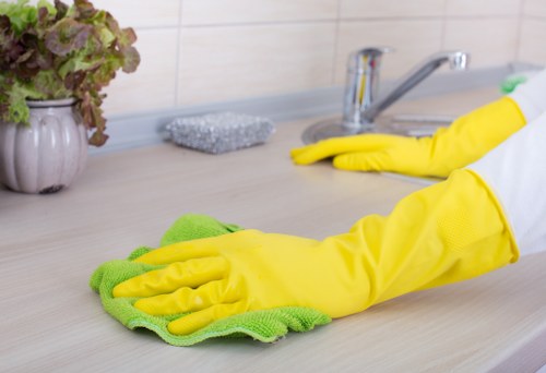 Cleaner tidying a kitchen as part of domestic cleaning in SE4